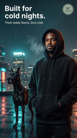 Man in a black teddy fleece hoodie on a city rooftop at night