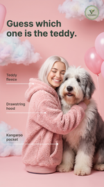 Woman in a pink teddy fleece hoodie hugging a sheepdog