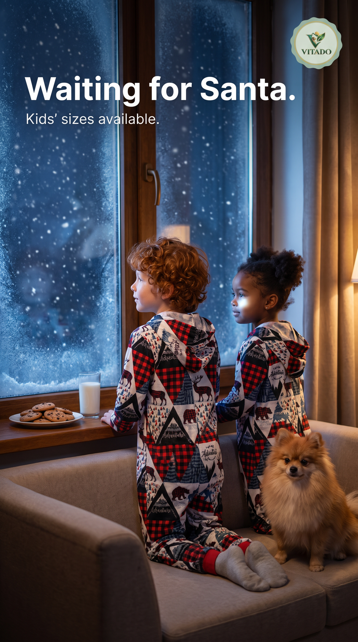 Kids in matching Christmas print onesies looking out at the snow